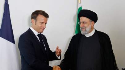 FILE - French President Emmanuel Macron holds a bilateral meeting with Iranian President Ebrahim Raisi on the sidelines of the 77th U.N. General Assembly at U.N. headquarters in New York City, Sept. 20, 2022.