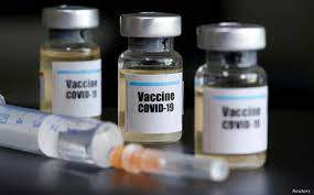 FILE - Small bottles labeled with a "Vaccine COVID-19" sticker and a medical syringe are seen in this illustration photo taken Apr. 10, 2020 - Reuters
