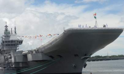 Indian navy officers gather on the deck of the Indian indigenous aircraft carrier INS Vikrant during its commissioning at Cochin Shipyard in Kochi, India, on Sept. 2, 2022. - India debuted its first locally made aircraft carrier, a milestone in government efforts to reduce its dependence on foreign arms and counter China's growing military assertiveness in the region. (Arun Sankar/AFP via Getty Images)