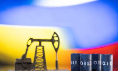 Models of oil barrels and a pump jack are displayed in front of Ukrainian and Russian flag colors in this illustration taken, on Feb. 24, 2022. (Dado Ruvic/Reuters)