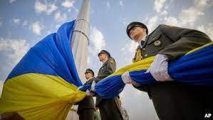 AP - In this photo provided by the Ukrainian Presidential Press Office, honour guard soldiers prepare to rise the Ukrainian national flag during State Flag Day celebrations in Kyiv, Ukraine, Aug. 23, 2022.