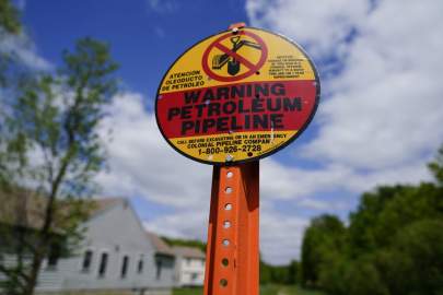 A warning sign is posted along the path of the Colonial Pipeline in Garnet Valley, Pa., on Monday. Russia has denied any involvement in the cyberattack on the pipeline.(MATT ROURKE/AP)